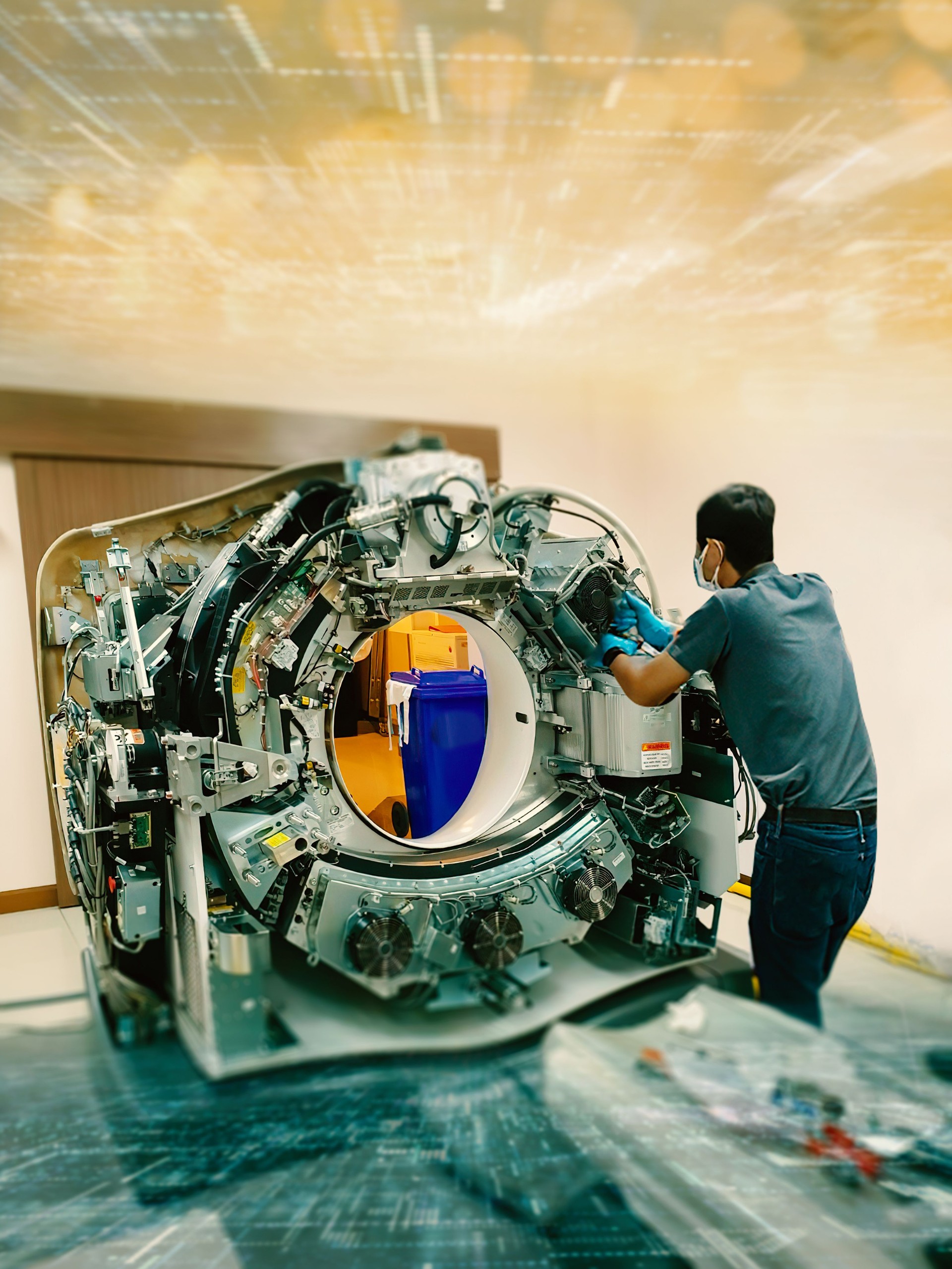 Maintenance engineer repairing and checking CT scanner machine