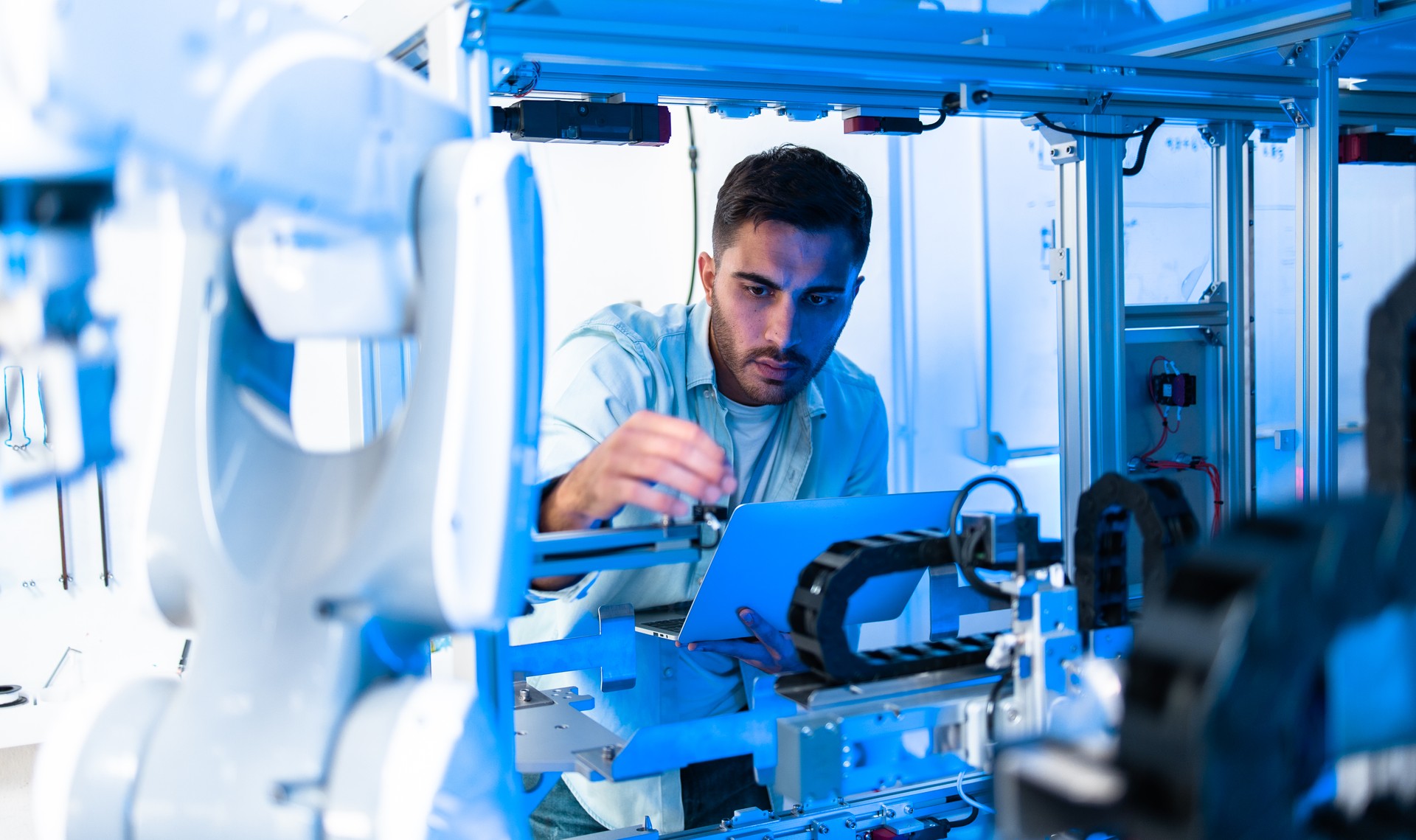 Team of engineers are conducting an experiment with robots.Close Up of a Futuristic Prosthetic Robot Arm Being Tested by a Professional Development Engineer